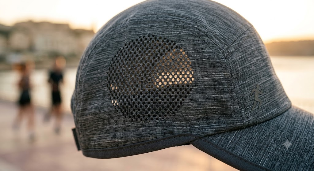 A close-up of high-performance technical fabric used in a modern running hat showing micro-perforations for ventilation.